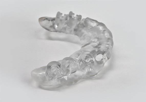 A translucent dental surgical guide printed with Raydent Surgical Guide Resin on Zortrax Inkspire 3D printer.
